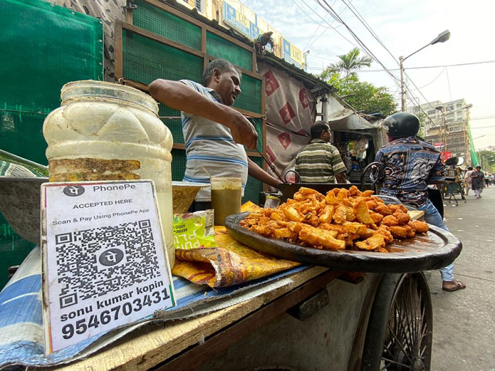 Sailendar Kumar, a pakoda (fritter) seller in the bustling south Kolkata street shopping hub Gariahat, says not only the sellers but even the customers have benefited more from the rise in the use of UPI. Photo by Avishek Mitra.
