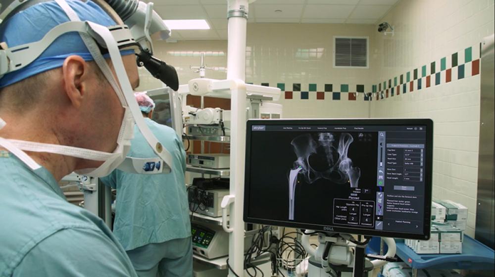 Doctor Jason Davis looks at an X-ray image of a patient’s hips to determine the next steps in the process at Henry Ford Hospital in Detroit. Photos provided by Henry Ford Health Orthopedics.