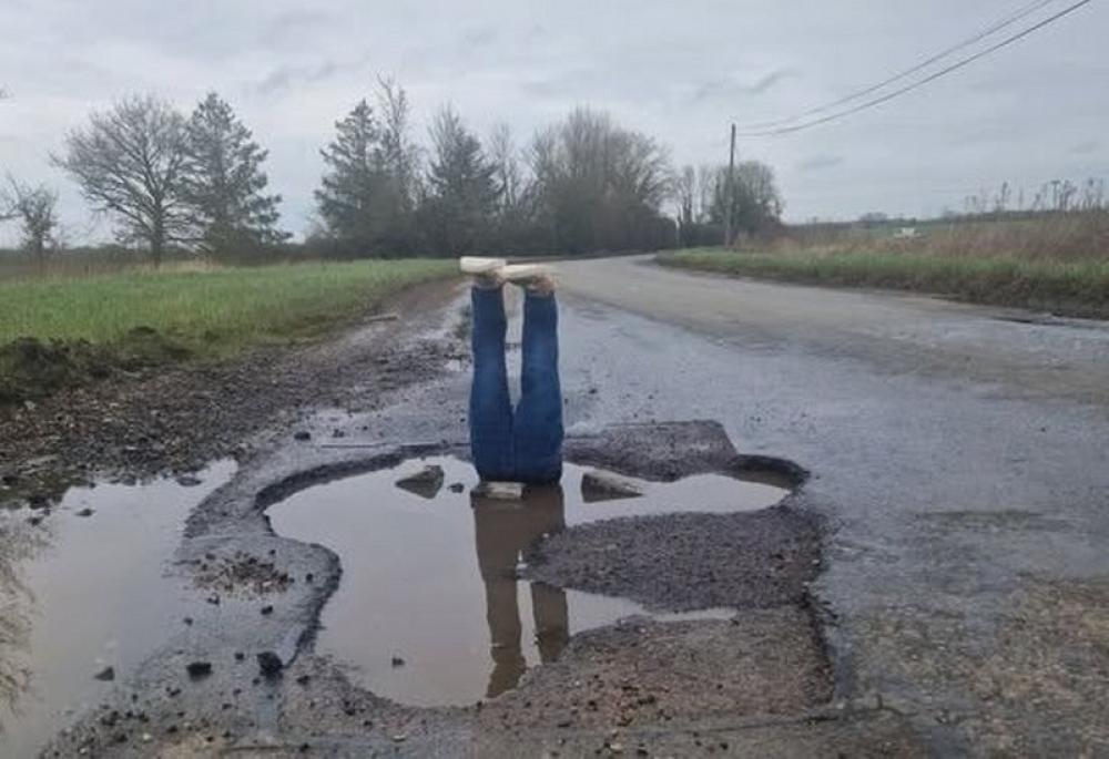 British man places fake pair of legs in large pothole to highlight plight of his village