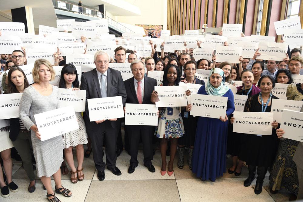 UN staff stands together marking World Humanitarian Day