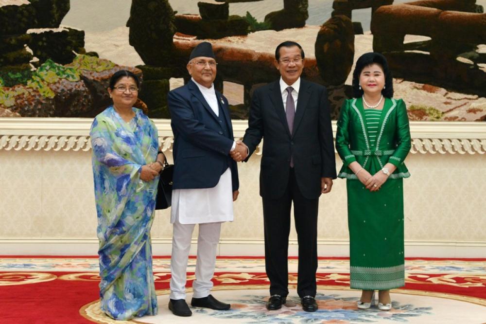 Cambodian Prime Minister Samdech Techo Hun Sen shakes hands with Nepalese Prime Minister K.P. Sharma Oli