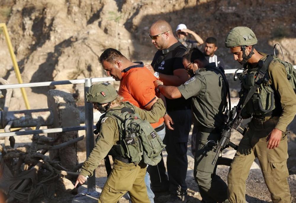 Israeli soldiers detain Palestinian protester during clashes in the northern part of Jordan valley